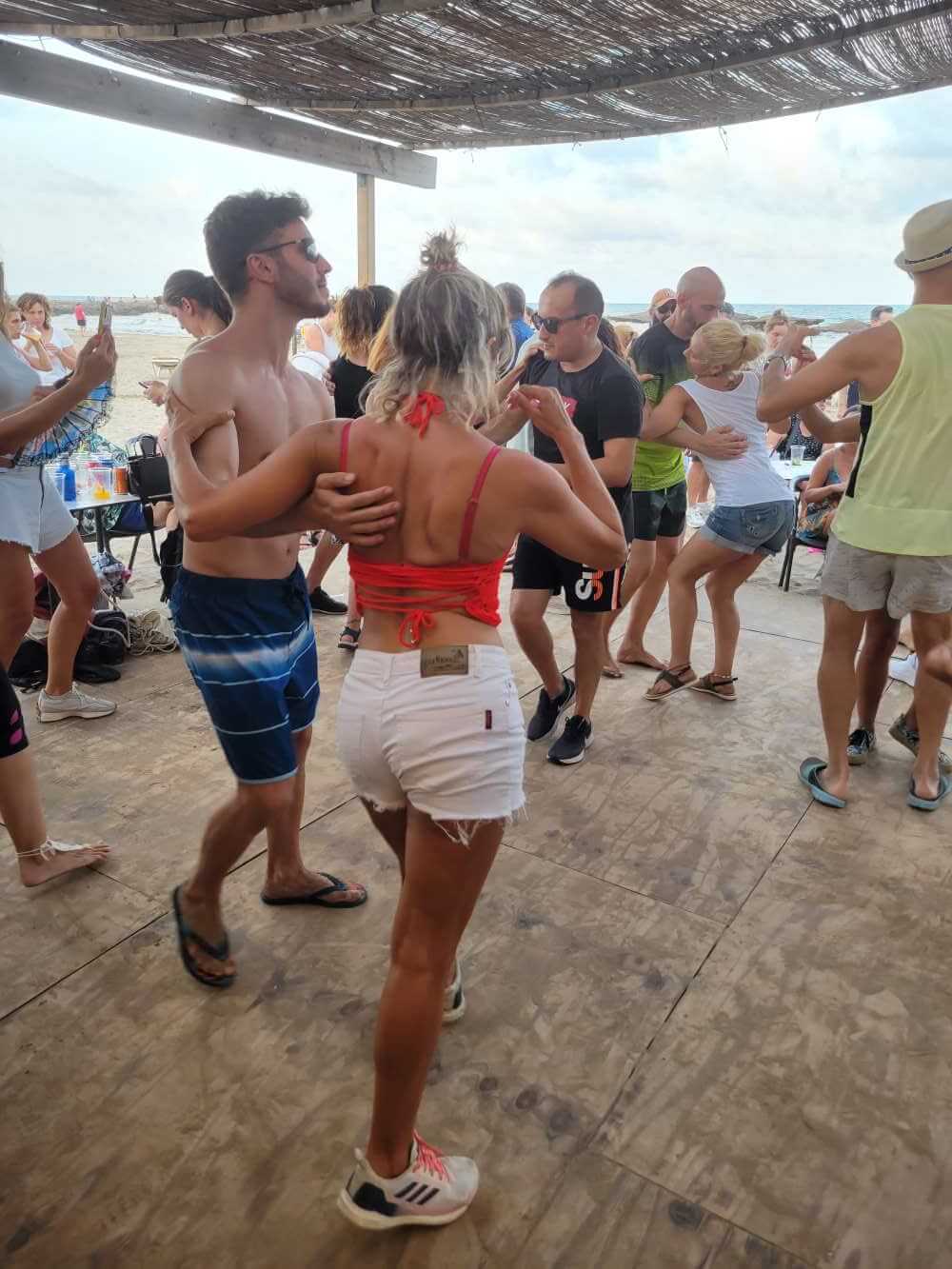 Young Man & Woman dancing Cuban Salsa near the beach in Valencia, Spain.
