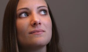 White Woman with blue eyes deep in thought on finding the right dance instructor.