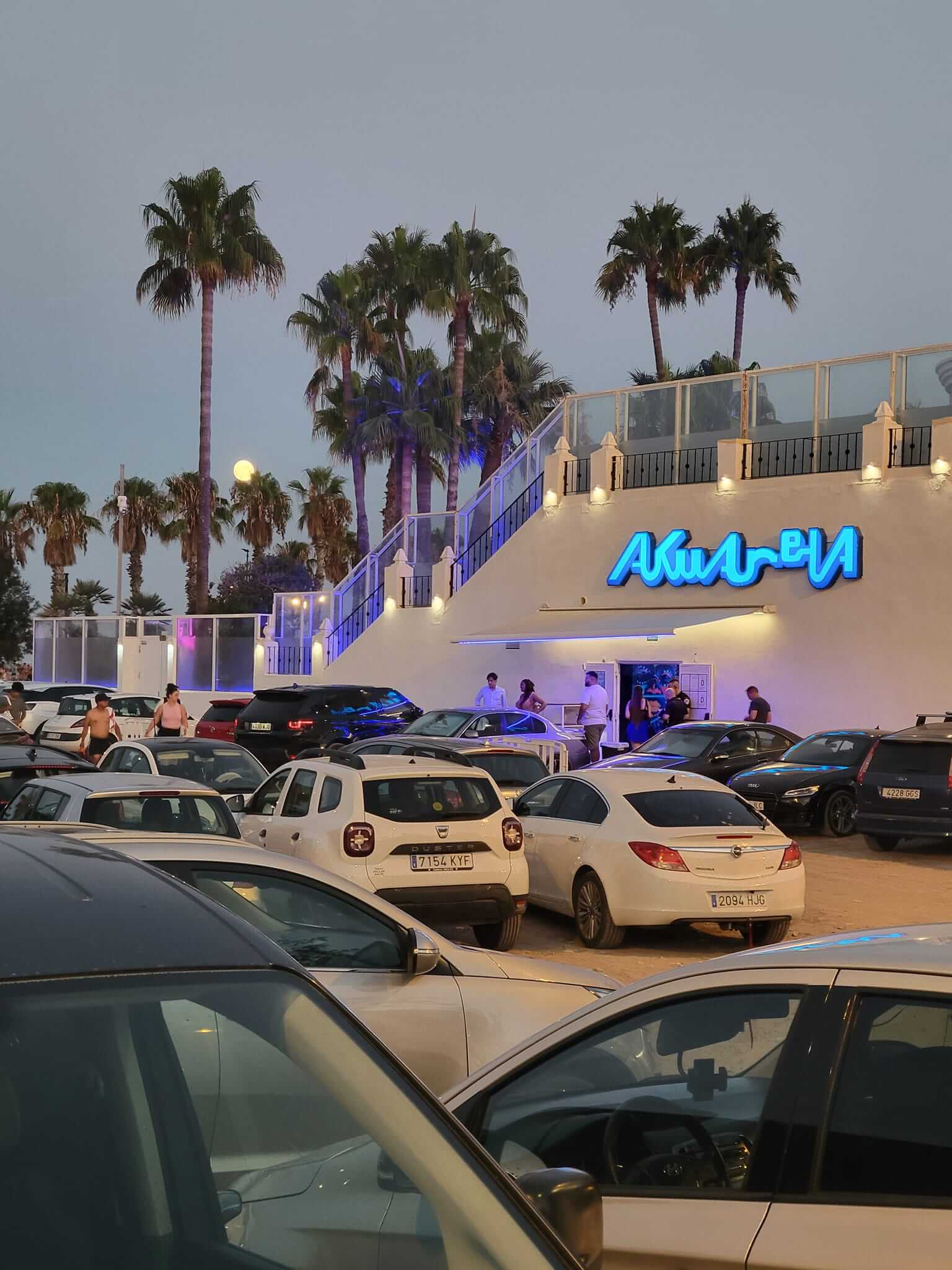 Akuarella Nightclub view at dusk with palm trees- Valencia, Spain
